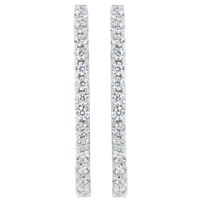 Front-facing shot of a pair of white metal earrings each set with a vertical line of round white gemstones in prong settings.
