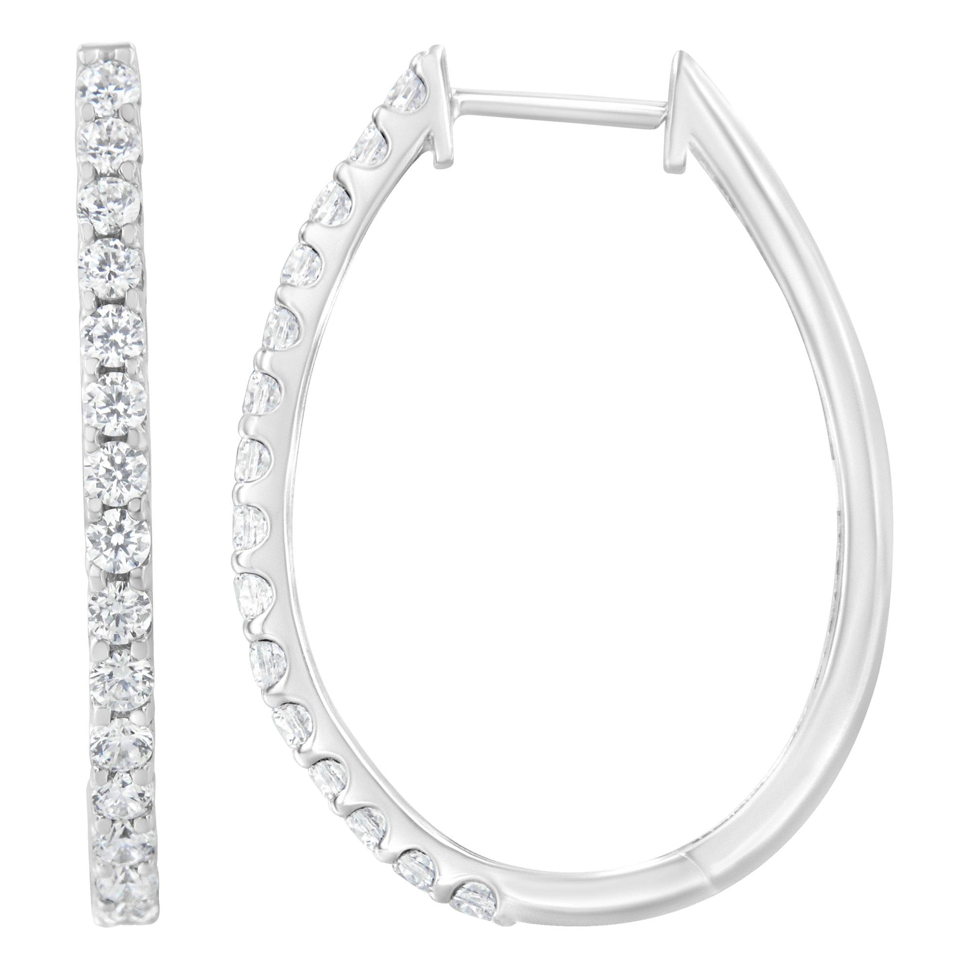 Close-up front and side view of white metal hoop earrings with prong-set round white gemstones.