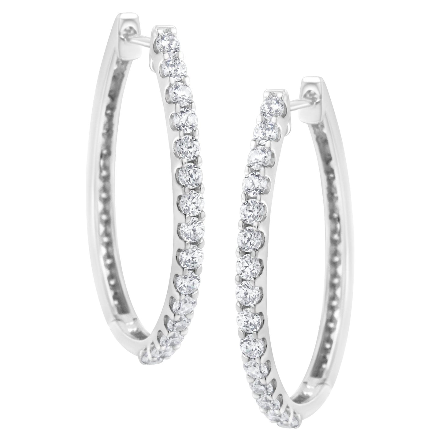 Front angled view of white metal hoop earrings set with round white gemstones in prong settings along the outer edge.