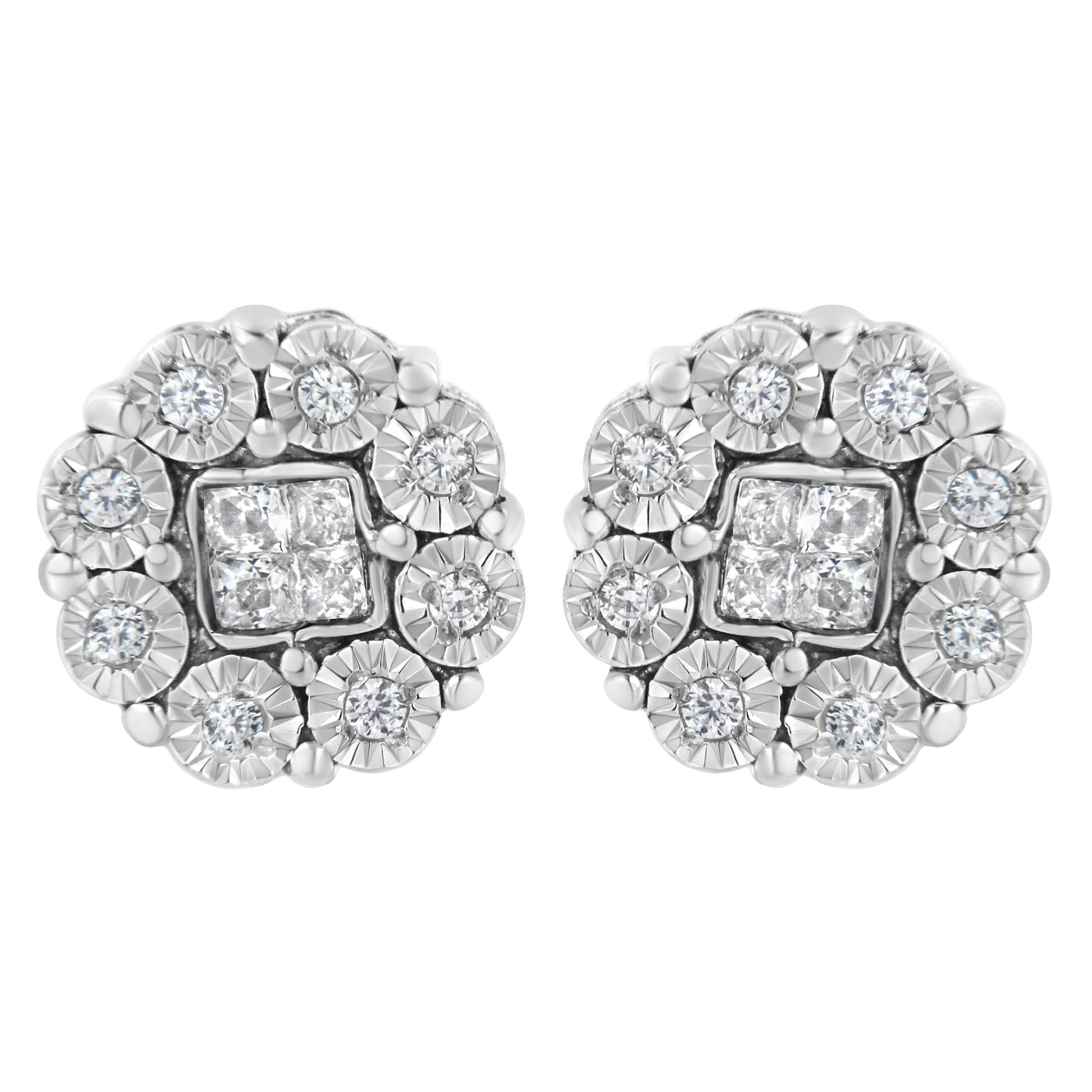 Close-up front view of a pair of white metal stud earrings featuring clusters of round white gemstones surrounded by square white gemstones in the center.