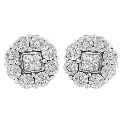 Close-up front view of a pair of white metal stud earrings featuring clusters of round white gemstones surrounded by square white gemstones in the center.