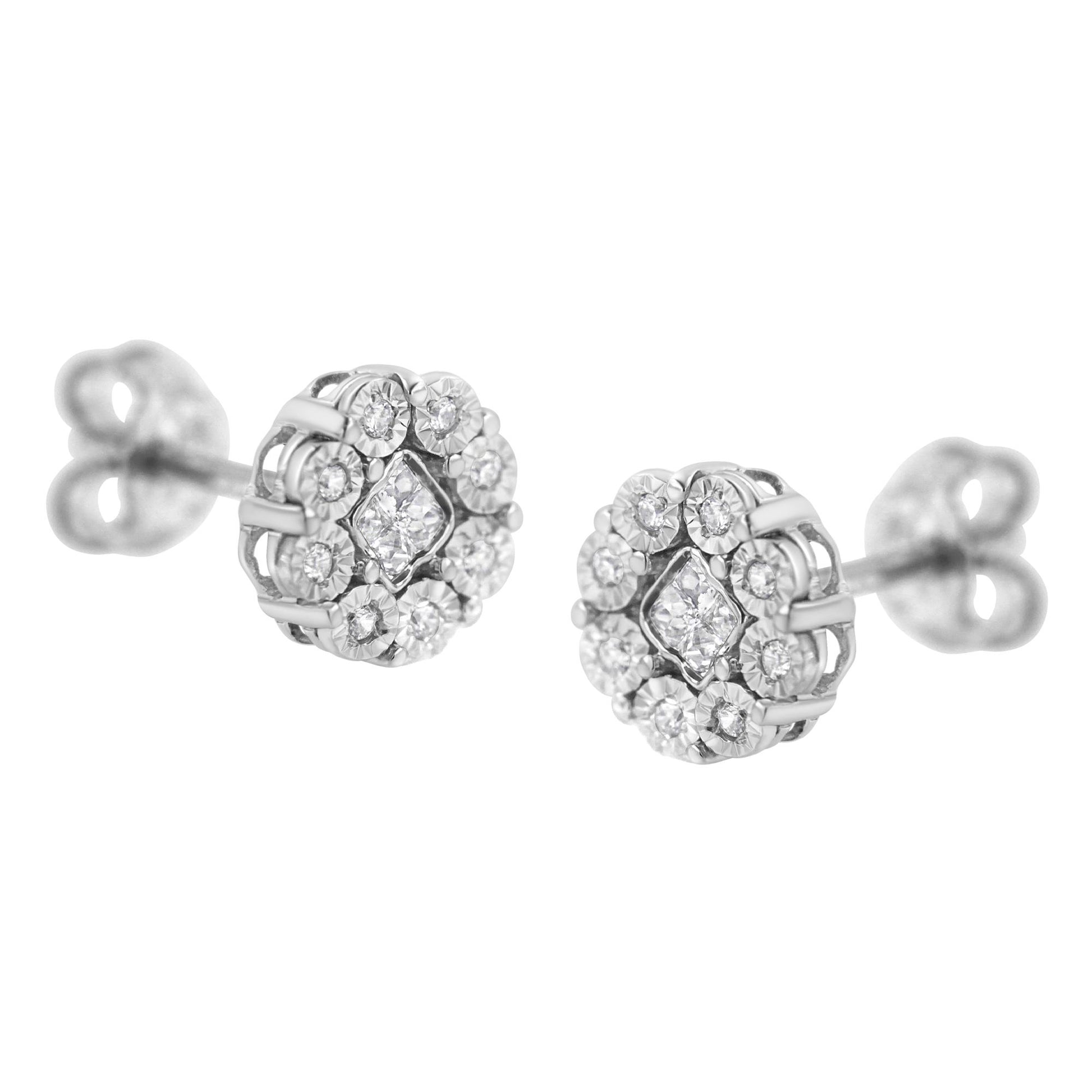Pair of white metal stud earrings with round and princess shaped white gemstones set in a floral cluster, shown from a front angled view.