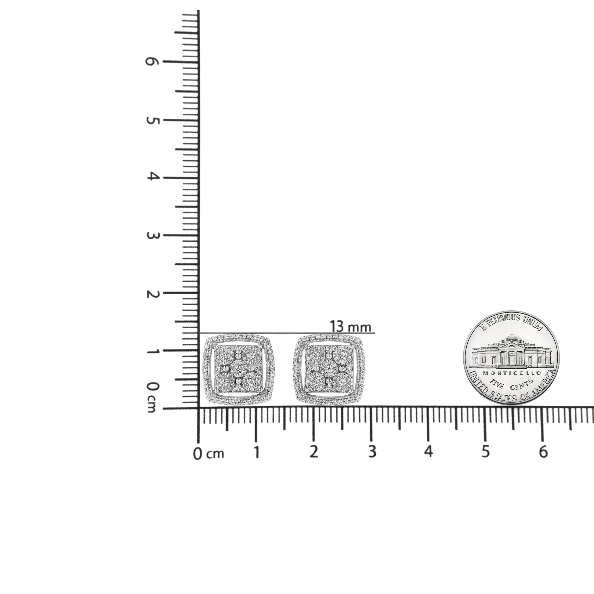 Pair of square-shaped white metal earrings with round white gemstones in miracle setting, shown from front on a ruler and scale for size reference.