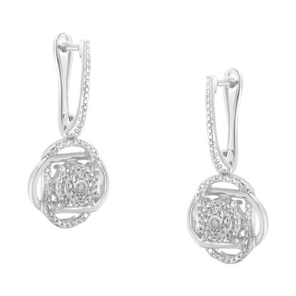 Front-facing view of a pair of white metal earrings featuring round white gemstones in a miracle setting with intricate circular and square design elements.
