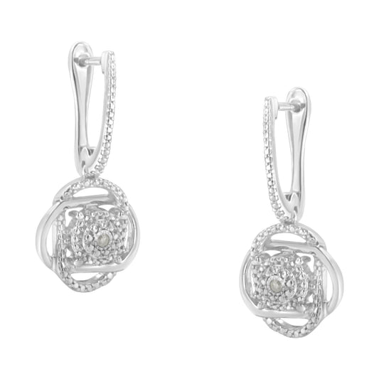 Front-facing view of a pair of white metal earrings featuring round white gemstones in a miracle setting with intricate circular and square design elements.