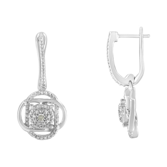 Front and side view of white metal drop earrings with circular design and small white gemstones in miracle setting.