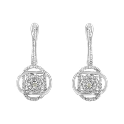 Front view of a pair of white metal drop earrings with circular and square designs, each featuring a round white gemstone in a miracle setting.