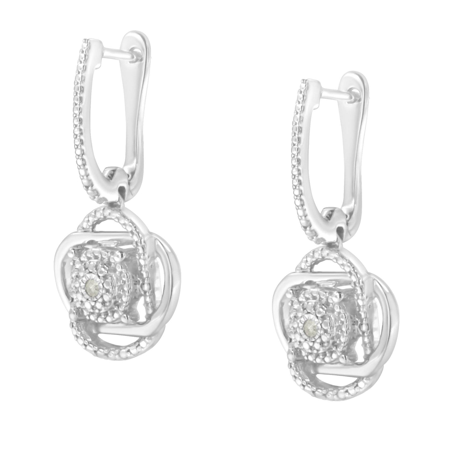 Front angled view of a pair of white metal drop earrings with round white gemstones in a miracle setting.