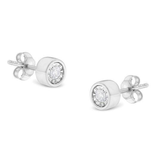 Pair of white metal stud earrings with round white gemstones in miracle settings, shown in a close-up angled view.