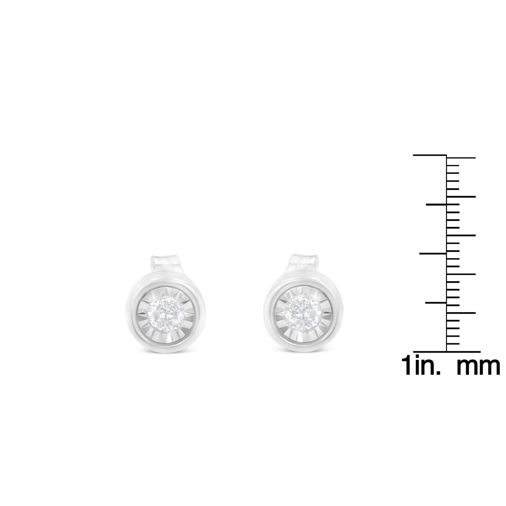 Front view of white metal round shaped stud earrings with white gemstones, shown beside a ruler for size reference.
