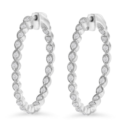 Front angled view of white metal hoop earrings with round white gemstones in prong settings.