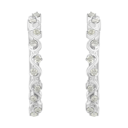 Front-facing close-up of white metal hoop earrings featuring round white gemstones in prong settings arranged in a swirl pattern.