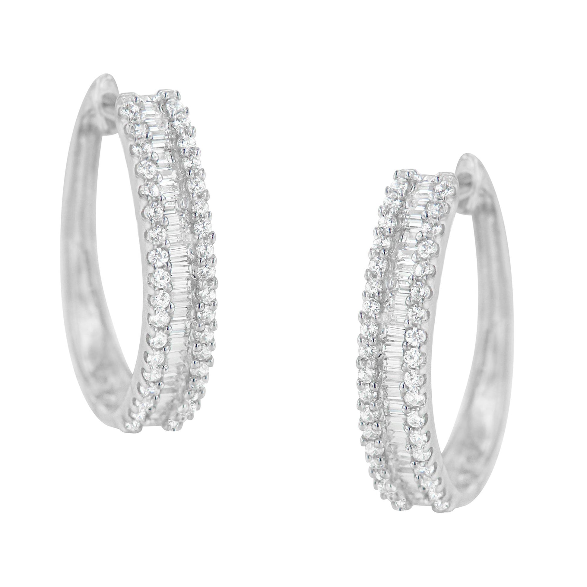Front-facing pair of white metal hoop earrings with pave-set round white gemstones flanking channel-set baguette white gemstones along the outer curve.