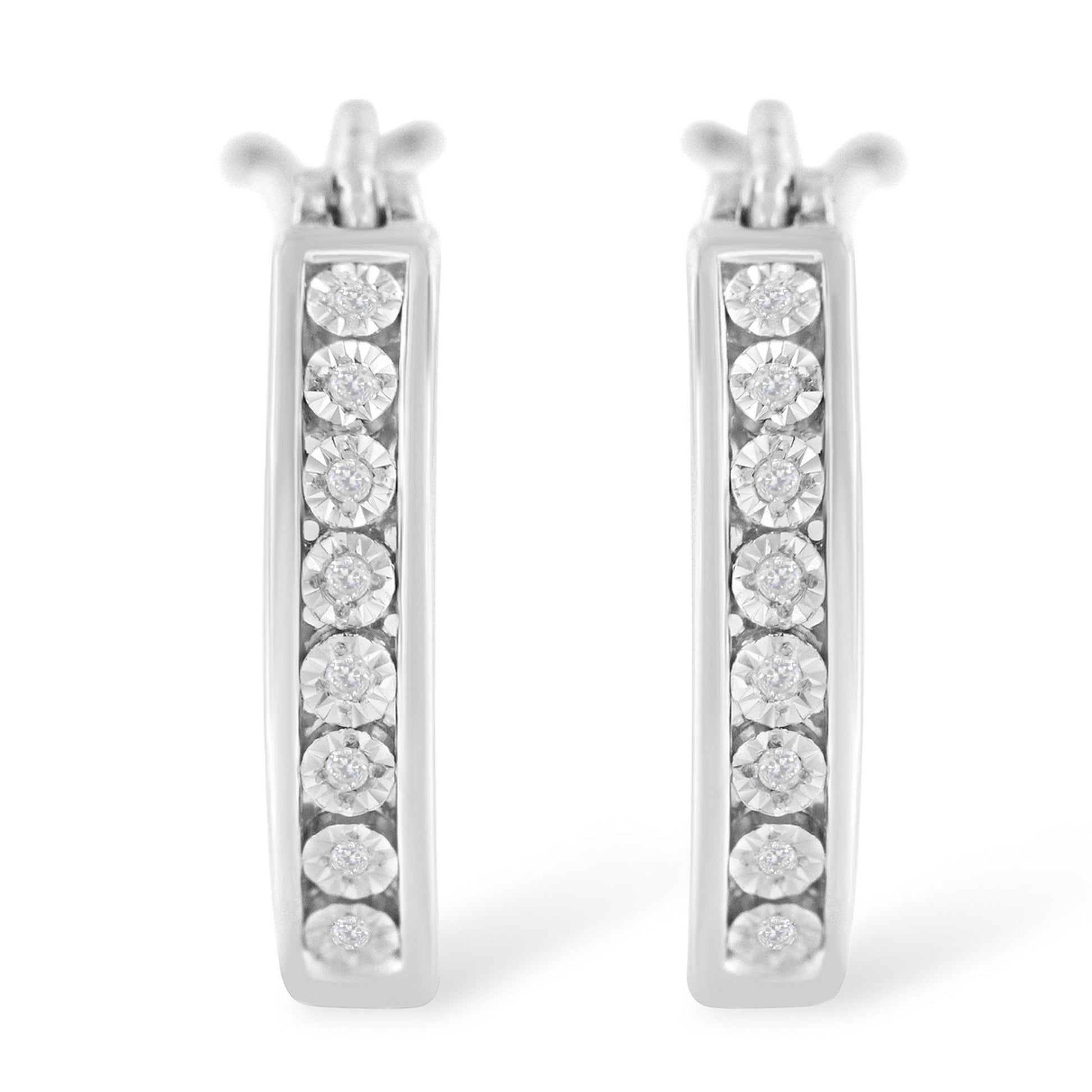 Front view of white metal hoop earrings with round white gemstones in a miracle setting.