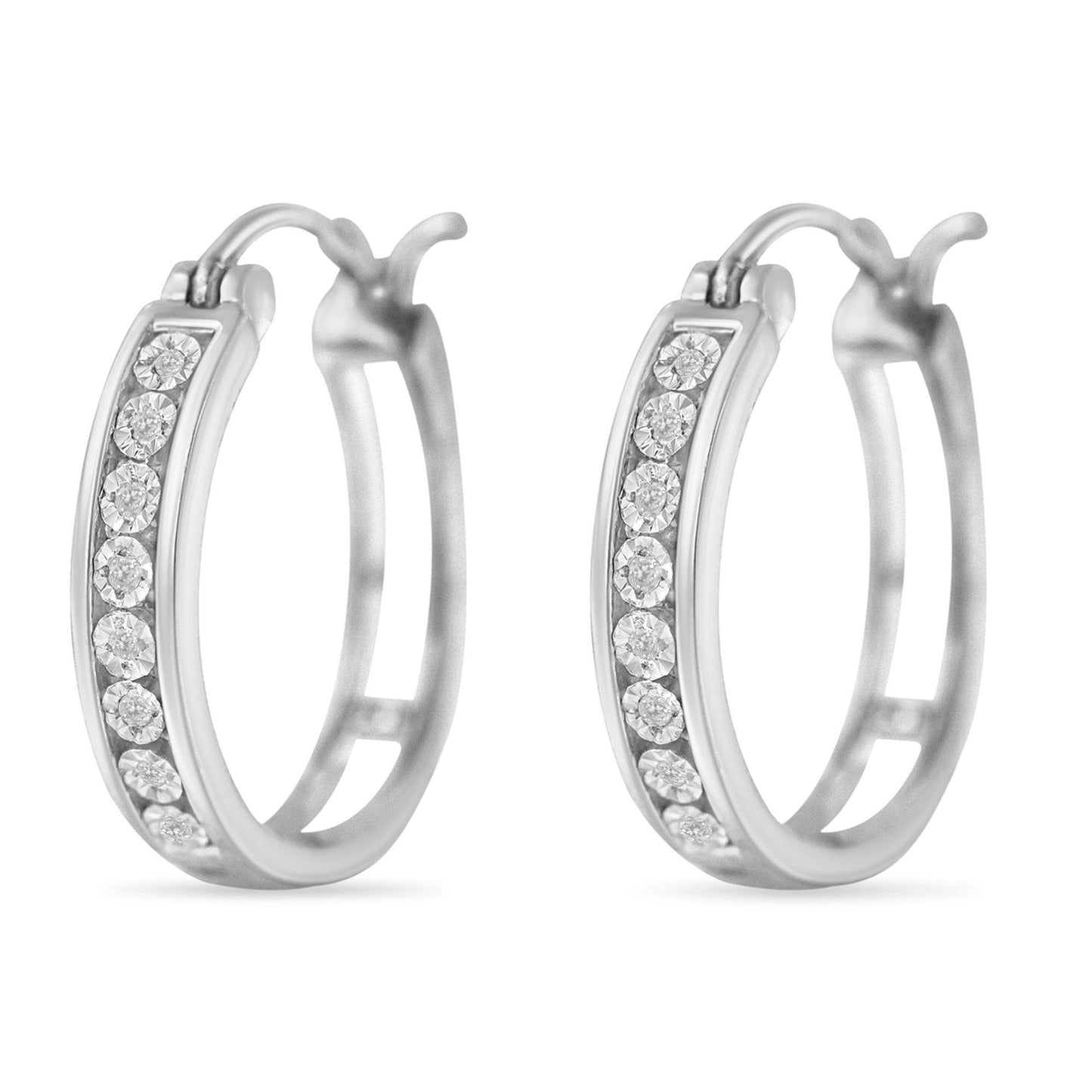 Pair of white metal hoop earrings with round white gemstones set along the outer edge, shown from a front angle.