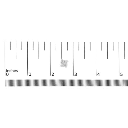 Close-up front view of a single white metal earring with a round white gemstone in a miracle setting, placed on a ruler for size reference.