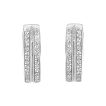 Front-facing shot of a pair of white metal earrings featuring two vertical rows of small round white gemstones set in pave style on each earring.
