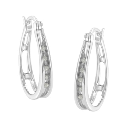 Pair of white metal hoop earrings with channel-set round white gemstones, shown at a three-quarter angle.