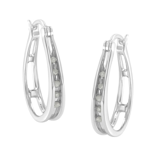 Pair of white metal hoop earrings with channel-set round white gemstones, shown at a three-quarter angle.