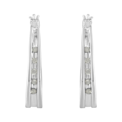 Front view of a pair of white metal earrings with multiple round white gemstones set in a channel setting.