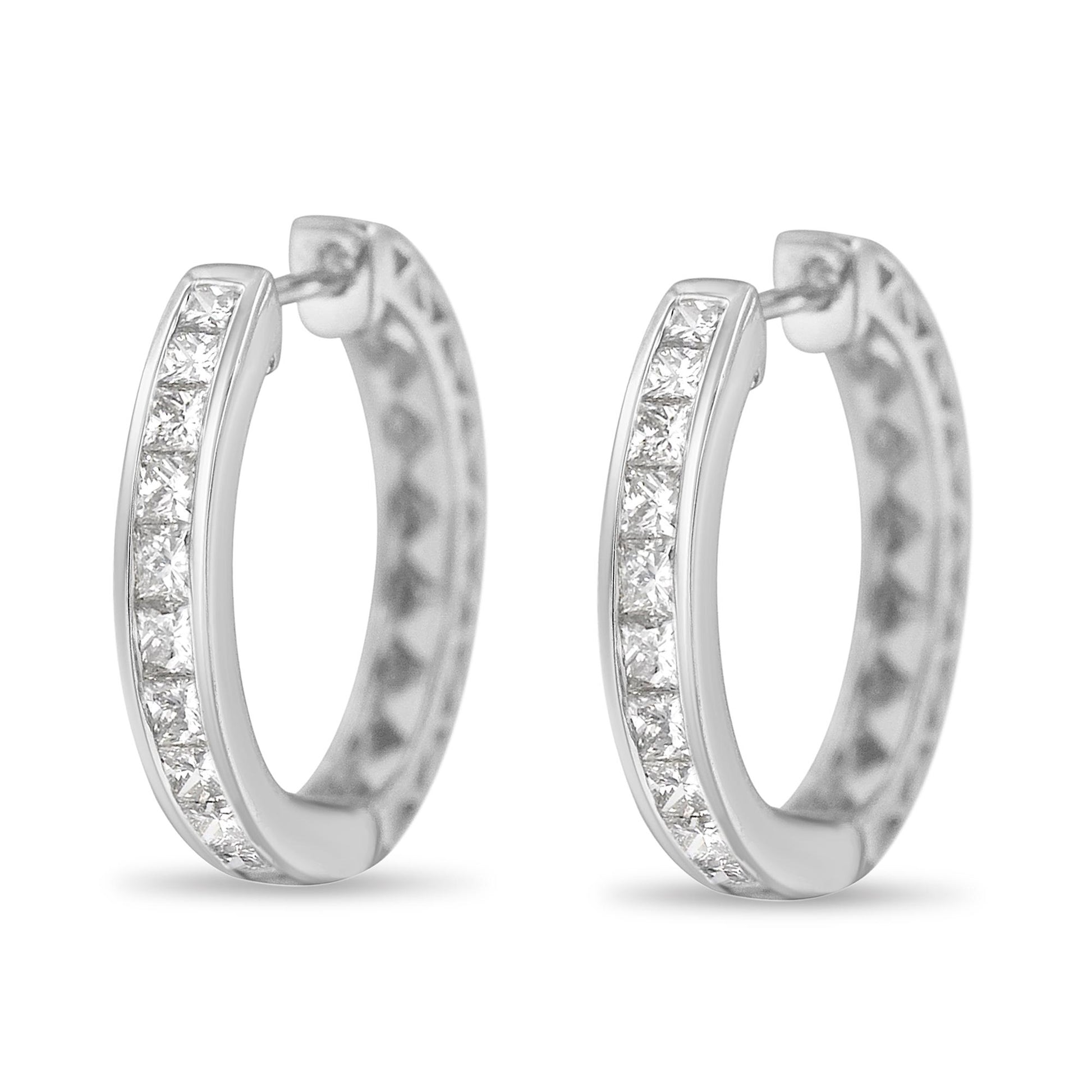 Pair of white metal hoop earrings with channel-set white princess shape gemstones, shown from a front perspective.