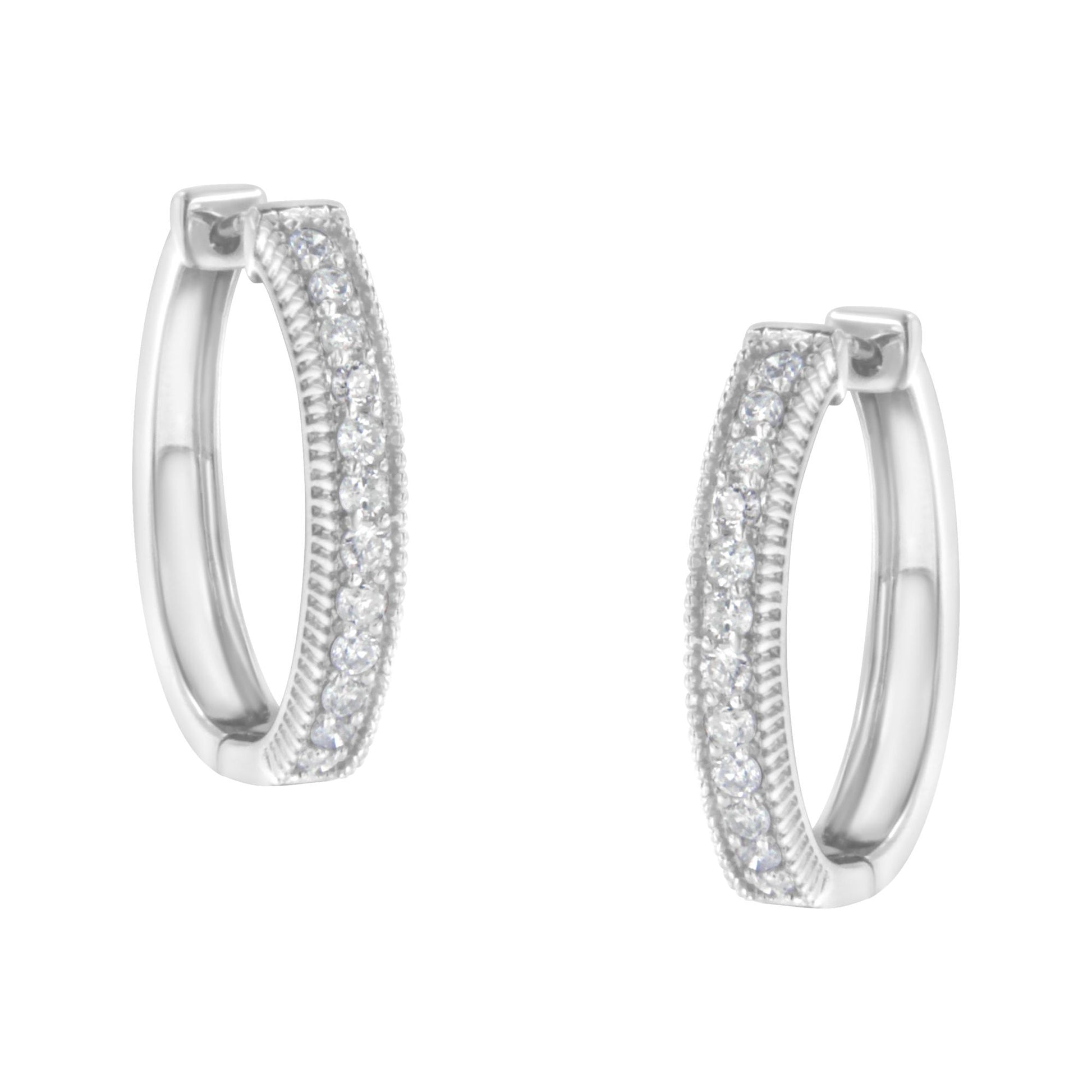 Pair of white metal hoop earrings with two rows of small round white gemstones in prong settings, shown from front angle.