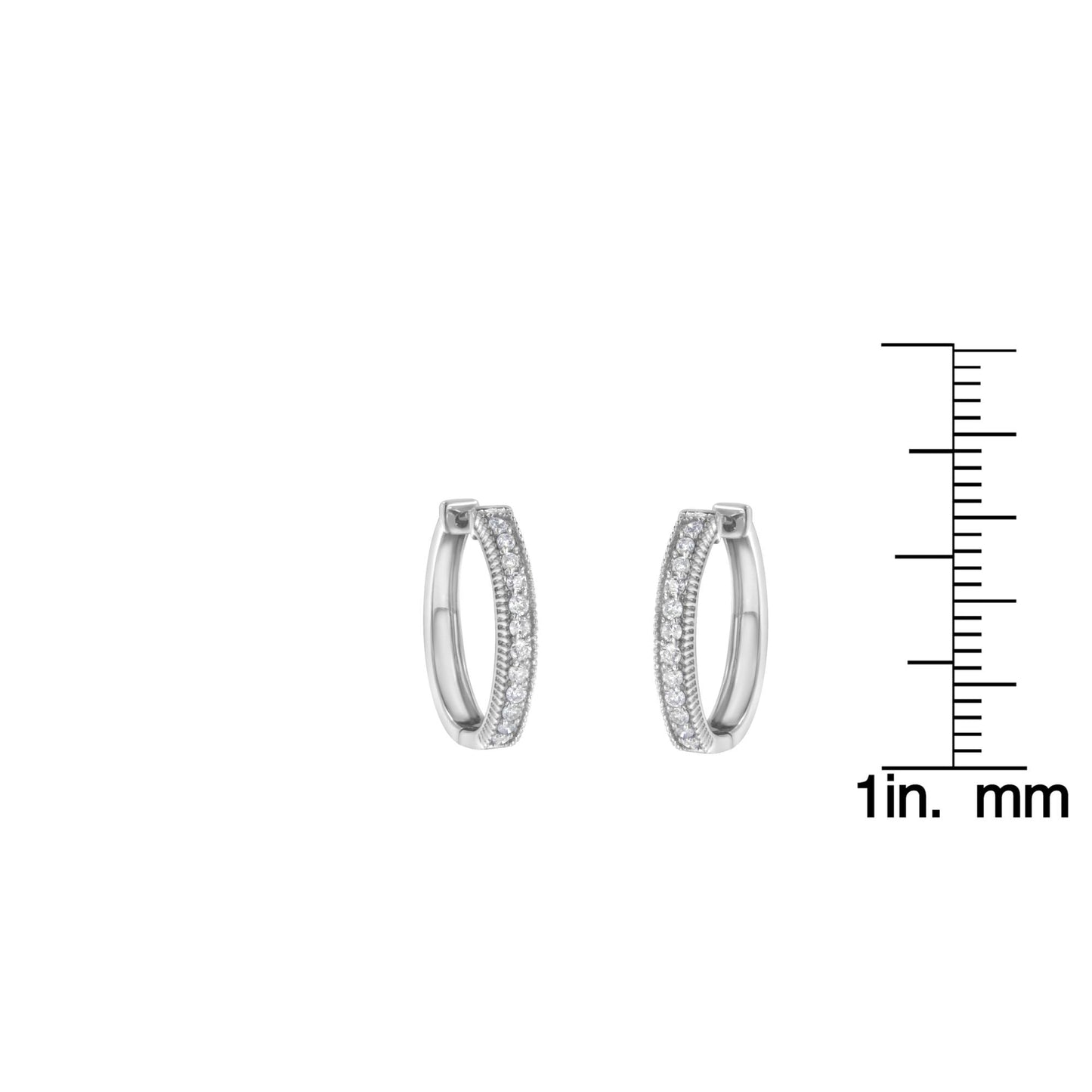Front-facing shot of white metal hoop earrings with rows of white round gemstones in prong settings, shown next to a ruler for size reference.