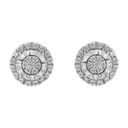 Front angle view of a pair of round white metal earrings with concentric circles of prong-set white gemstones.