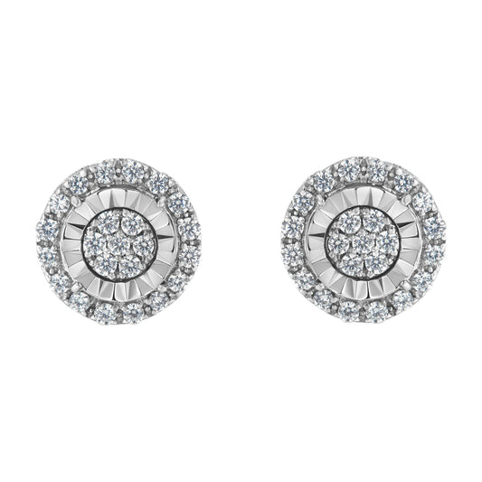 Front angle view of a pair of round white metal earrings with concentric circles of prong-set white gemstones.