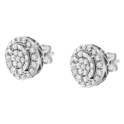 Pair of white metal stud earrings with round white gemstones in prong settings, shown at a slight angle.