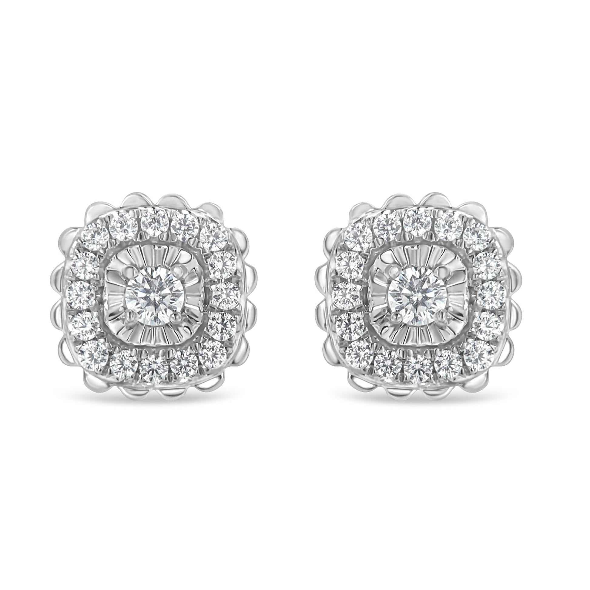 Front view of white metal stud earrings featuring a central round white gemstone in prong setting surrounded by two rows of round white gemstones, the inner row in miracle setting and the outer row in prong setting.
