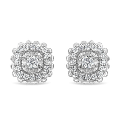 Front view of white metal stud earrings featuring a central round white gemstone in prong setting surrounded by two rows of round white gemstones, the inner row in miracle setting and the outer row in prong setting.