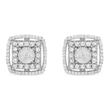 Pair of white metal square-shaped earrings with round bezel-set white gemstones in the center, surrounded by multiple round shared-prong-set white gemstones, shown from the front angle.