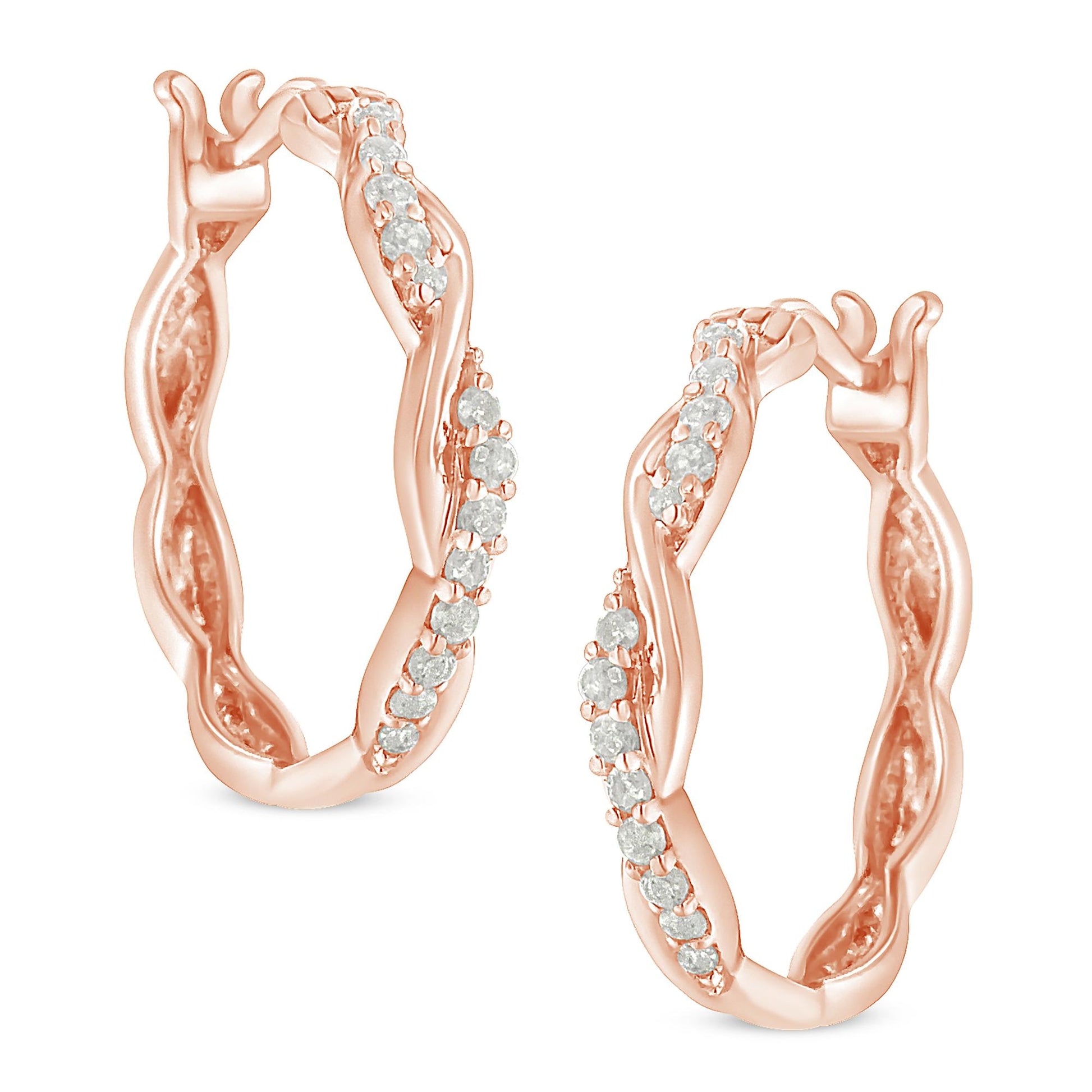 Close-up front angle of a pair of rose-colored hoop earrings with a twisted design and white round gemstones in pave setting.