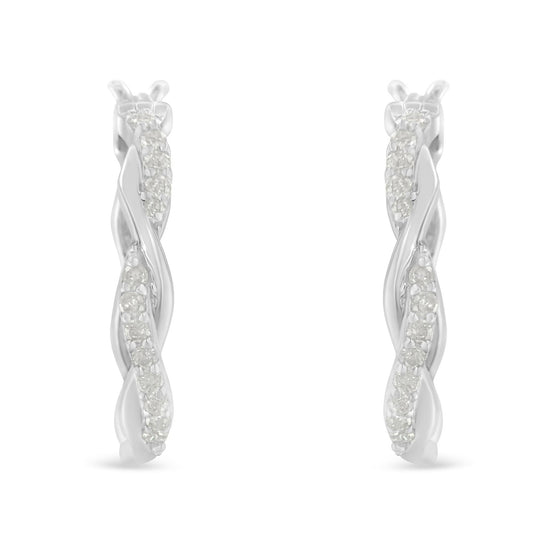 Front-facing close-up of white metal twisted hoop earrings with a row of round white gemstones in a pave setting.