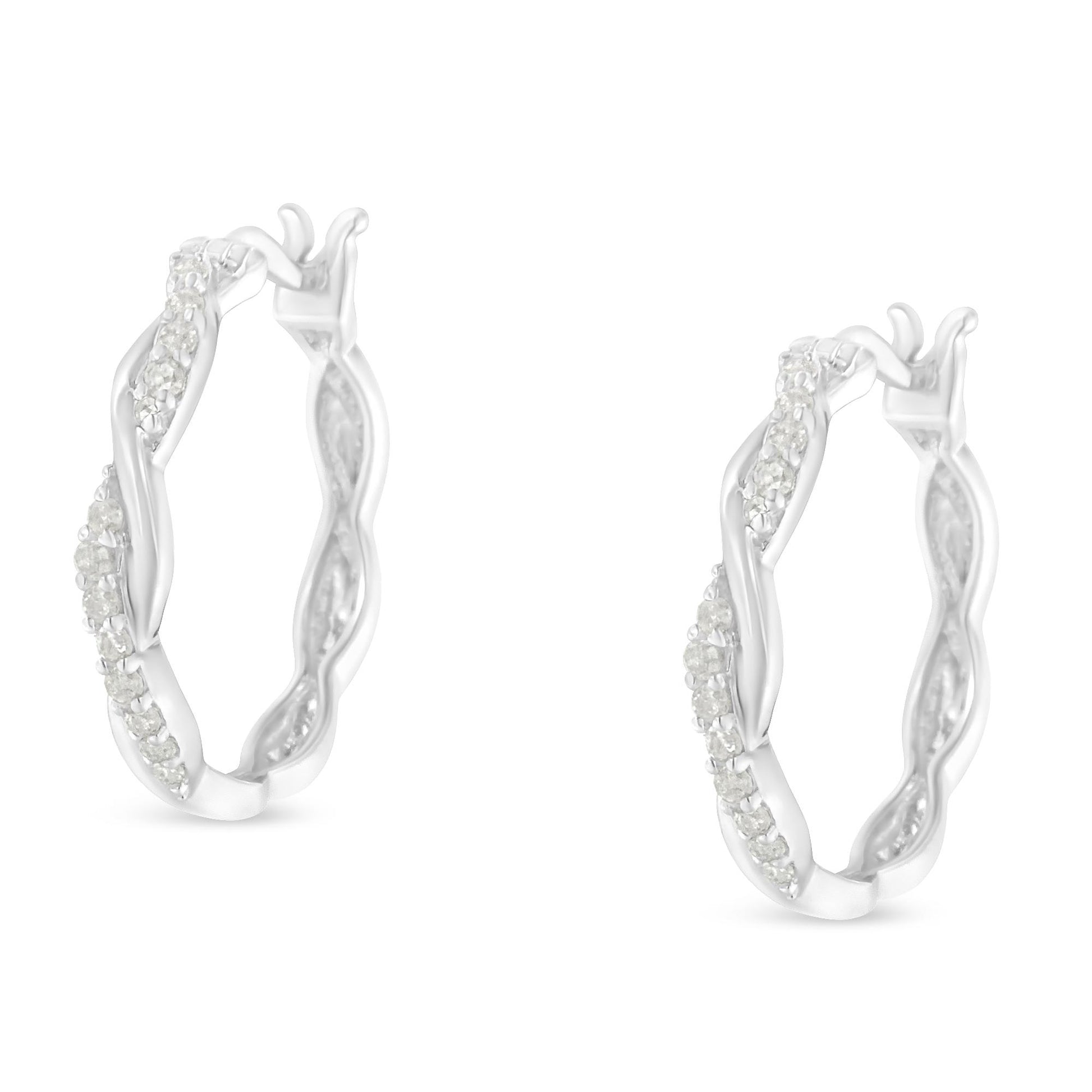 Pair of white metal hoop earrings with twisted design, adorned with white round pave-set gemstones, shown from a front angle.