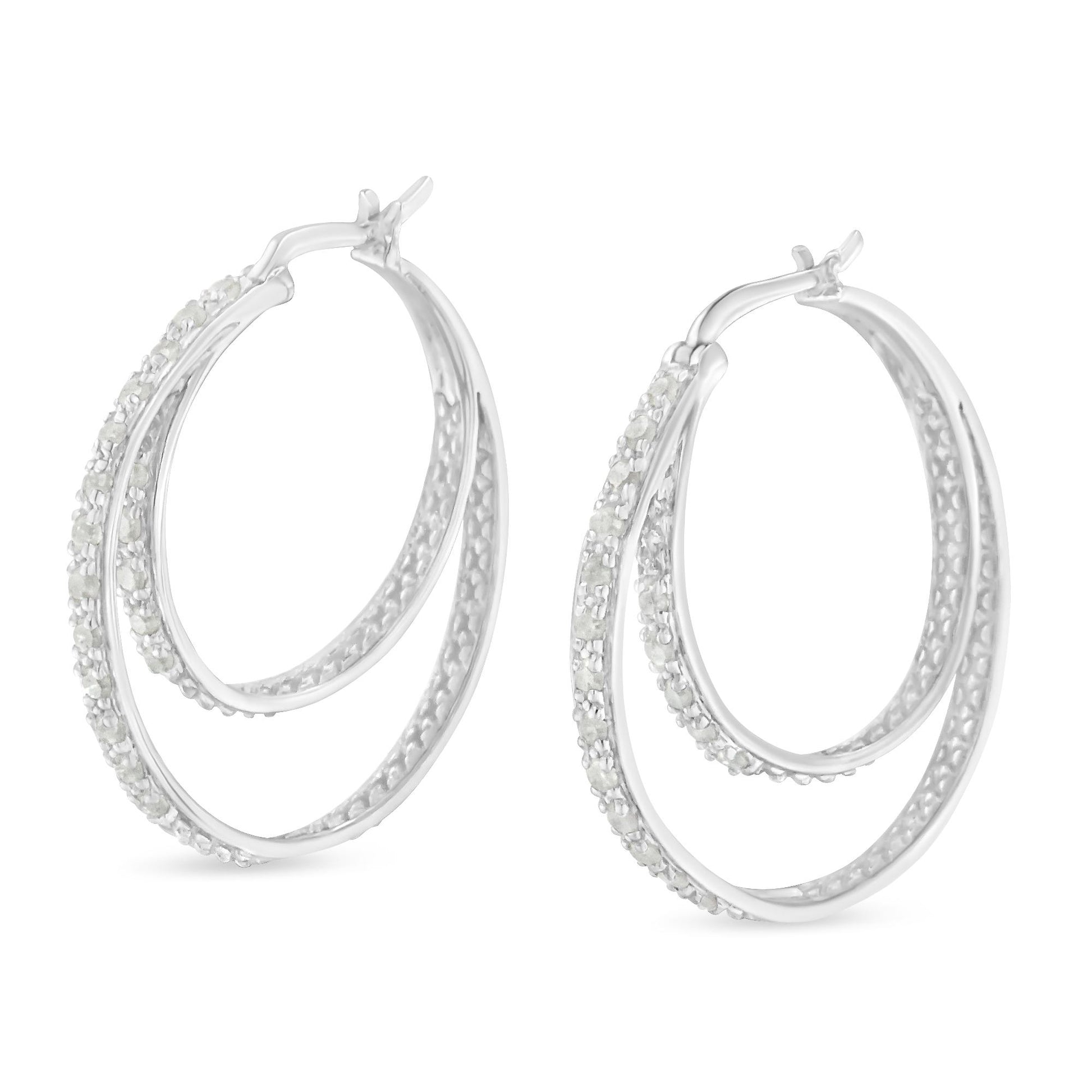 Pair of white metal double hoop earrings with pave-set white round gemstones, shown from a slight side angle.
