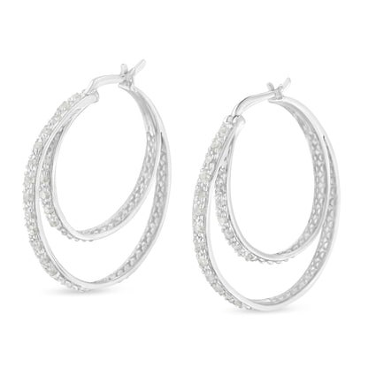 Pair of white metal double hoop earrings with pave-set white round gemstones, shown from a slight side angle.