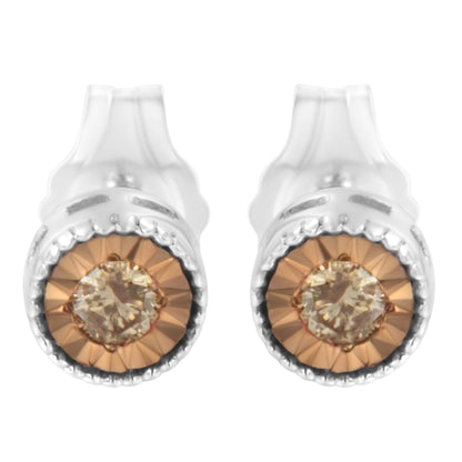 Front angle view of a pair of white metal stud earrings featuring round champagne-colored gemstones with a faceted miracle setting.