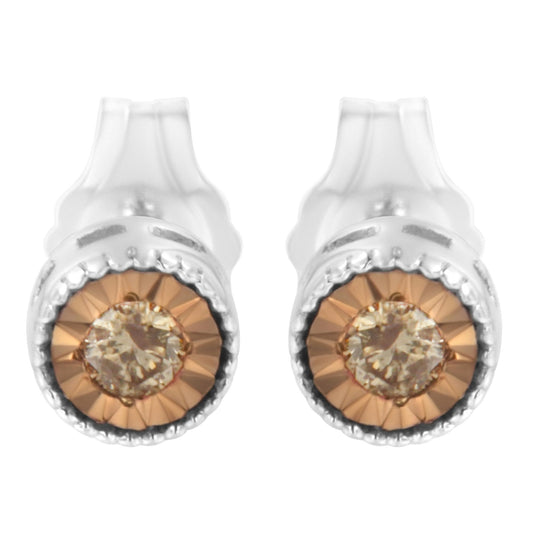 Front angle view of a pair of white metal stud earrings featuring round champagne-colored gemstones with a faceted miracle setting.