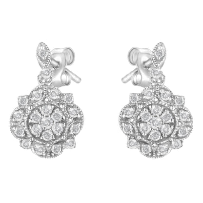 Front-facing view of a pair of white metal stud earrings with round white gemstones in prong settings arranged in floral cluster patterns.