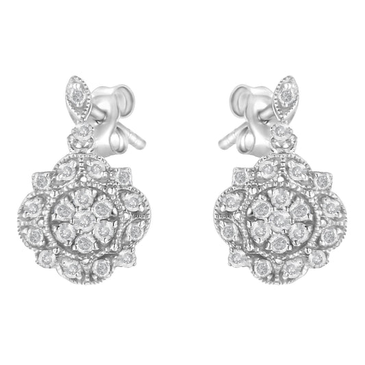 Front-facing view of a pair of white metal stud earrings with round white gemstones in prong settings arranged in floral cluster patterns.