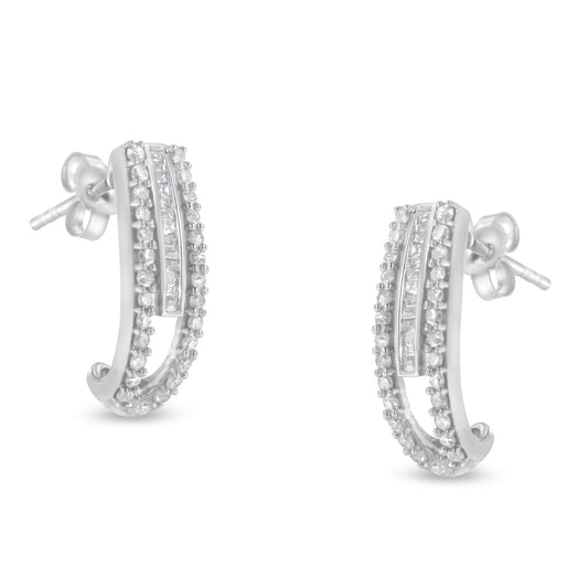 Pair of white metal earrings with curved design featuring rows of round prong-set white gemstones and a central channel-set row of baguette white gemstones, shown from front angle.