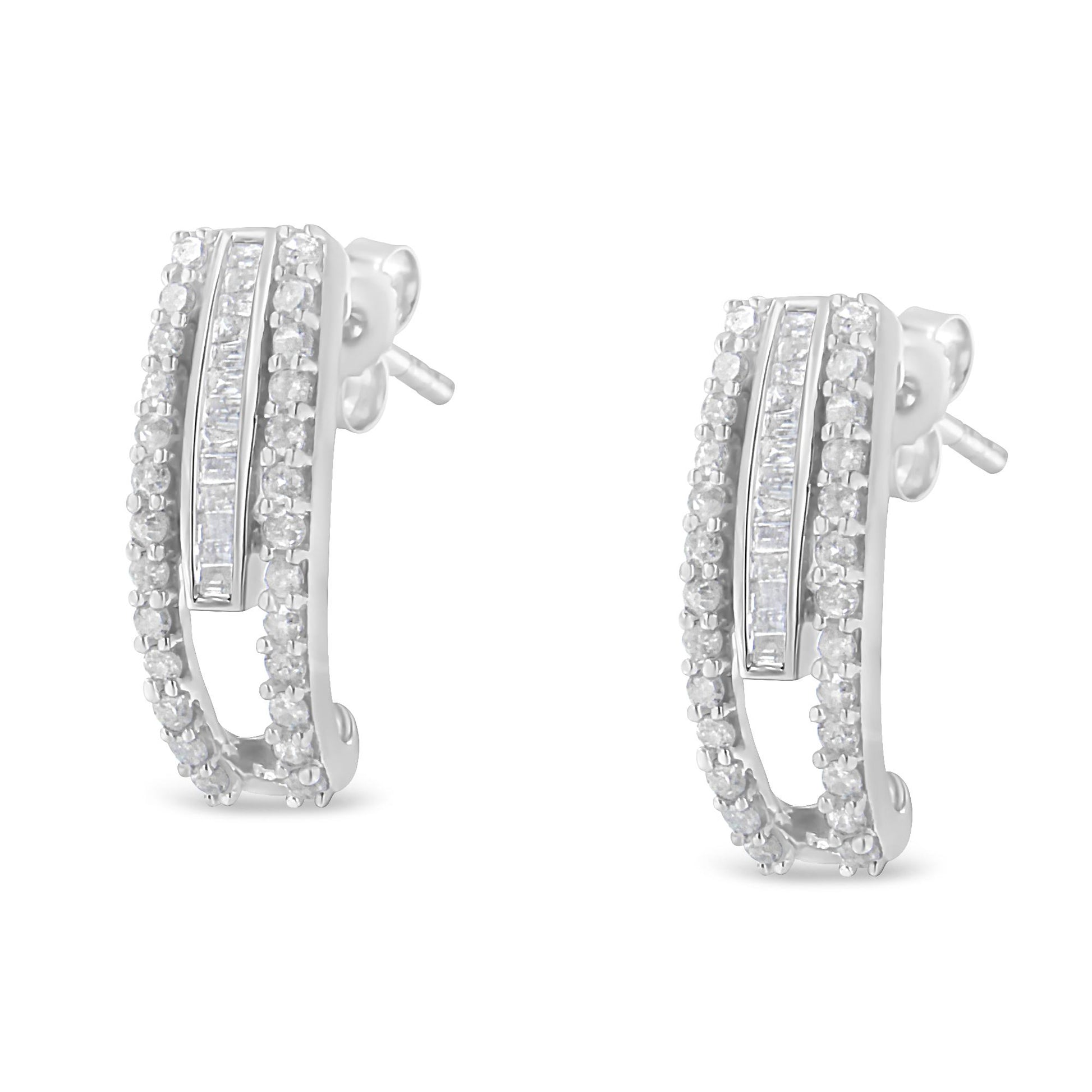 Pair of white metal earrings with curved design, featuring rows of round prong-set white gemstones bordering a center row of baguette channel-set white gemstones, shown in a front-facing angle.
