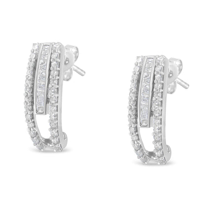 Pair of white metal earrings with curved design, featuring rows of round prong-set white gemstones bordering a center row of baguette channel-set white gemstones, shown in a front-facing angle.