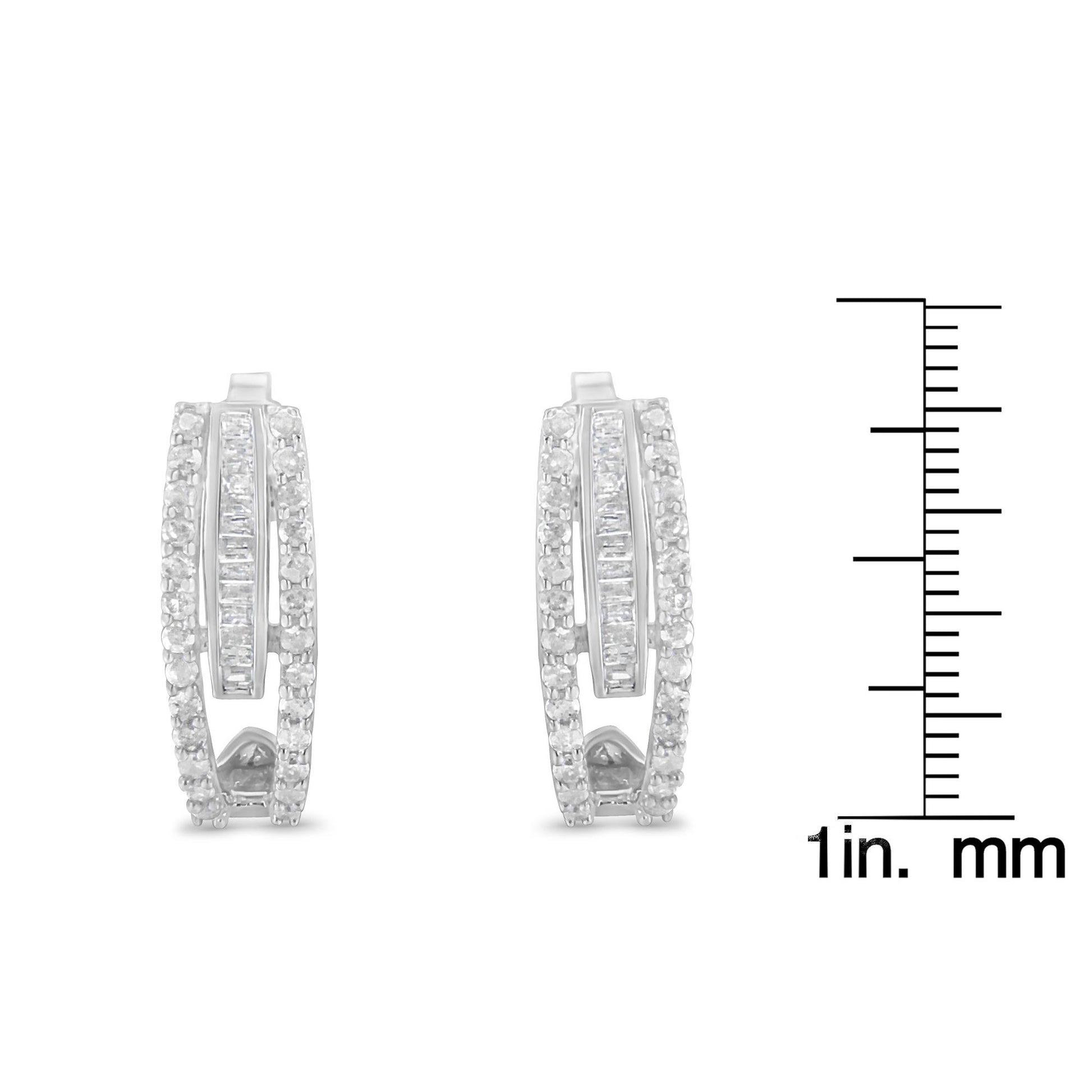 Front-facing white metal earrings with round prong-set white gemstones along the edges and baguette channel-set white gemstones in the center, shown with a ruler for size reference.