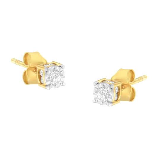 Close-up angle of a pair of yellow metal stud earrings with round white gemstones set in a miracle setting.