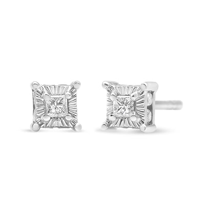 Front and side angle of white metal stud earrings with square prong-set white gemstones and additional round channel-set white gemstones visible on the side.