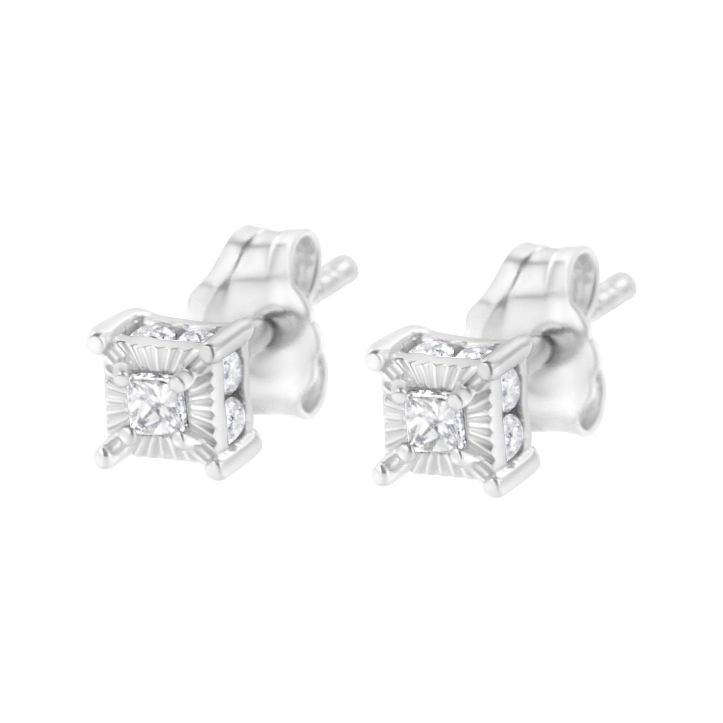 Pair of white metal stud earrings with princess shape white gemstones in prong settings at the center, surrounded by round shape white gemstones in channel settings, shown from a front angle.