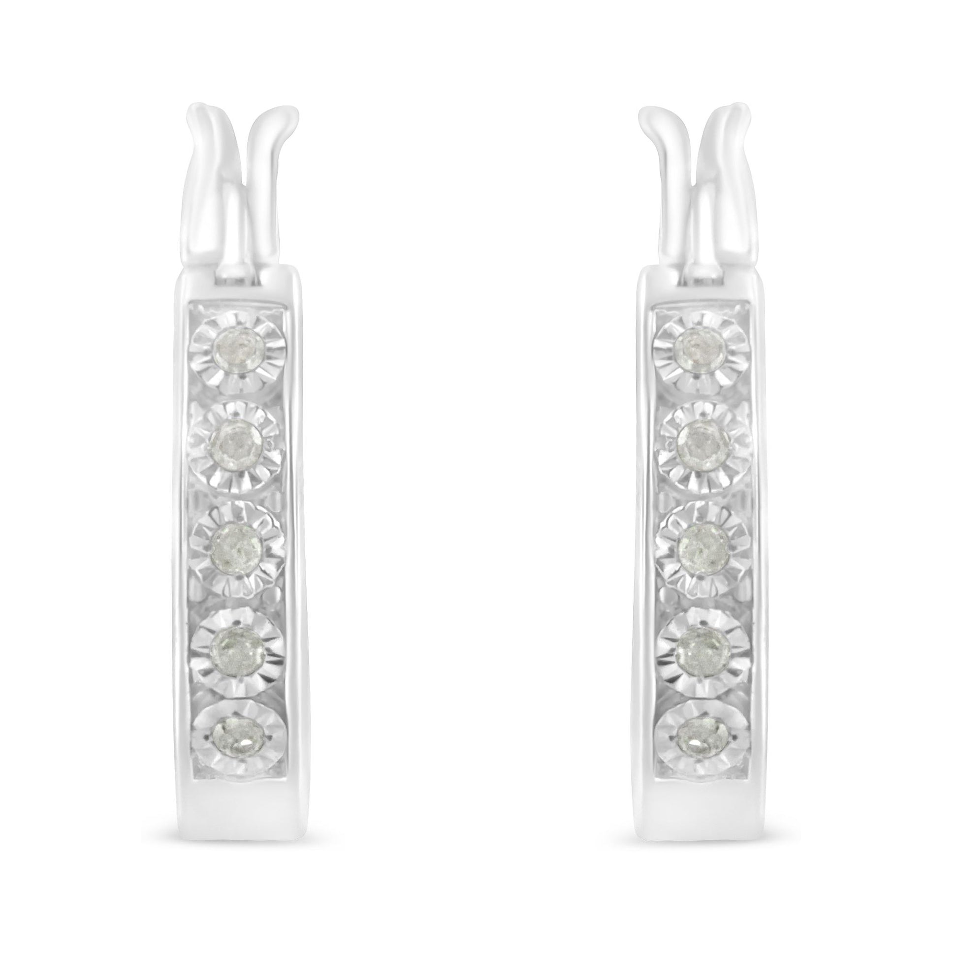 Front-facing view of white metal hoop earrings with round white gemstones in miracle setting.
